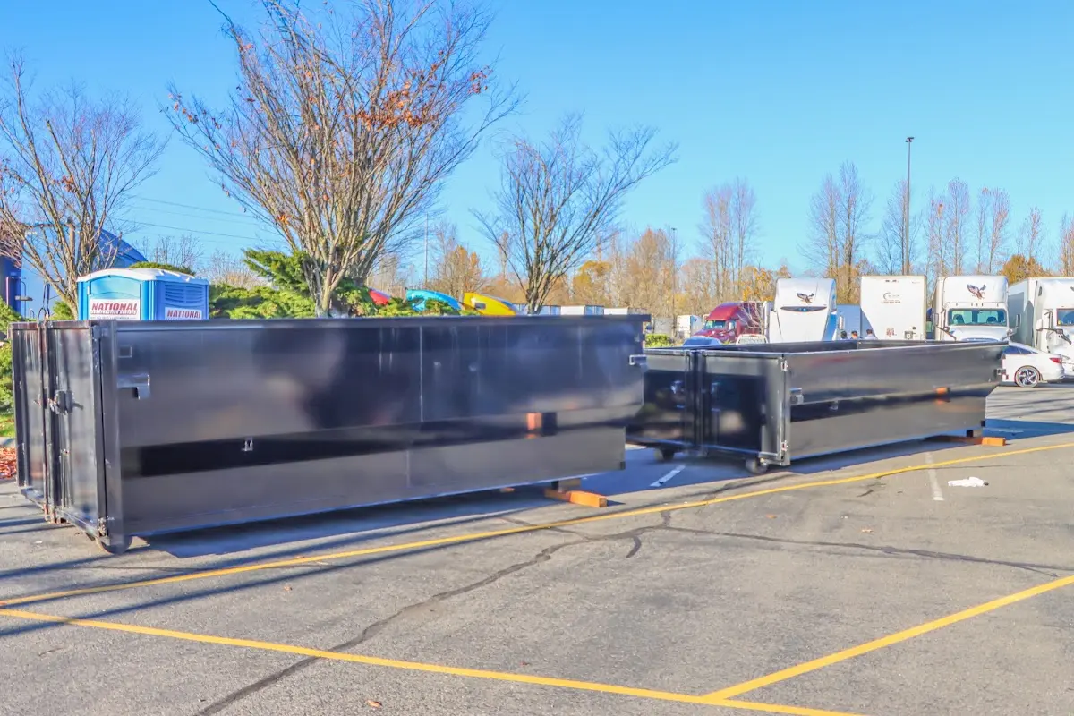 Professional dumpster rental service with roll-off container on residential driveway in Pasco